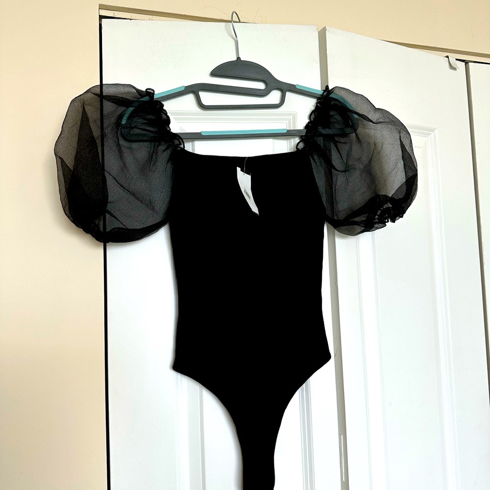 Puff sleeved body suit. Never worn.
